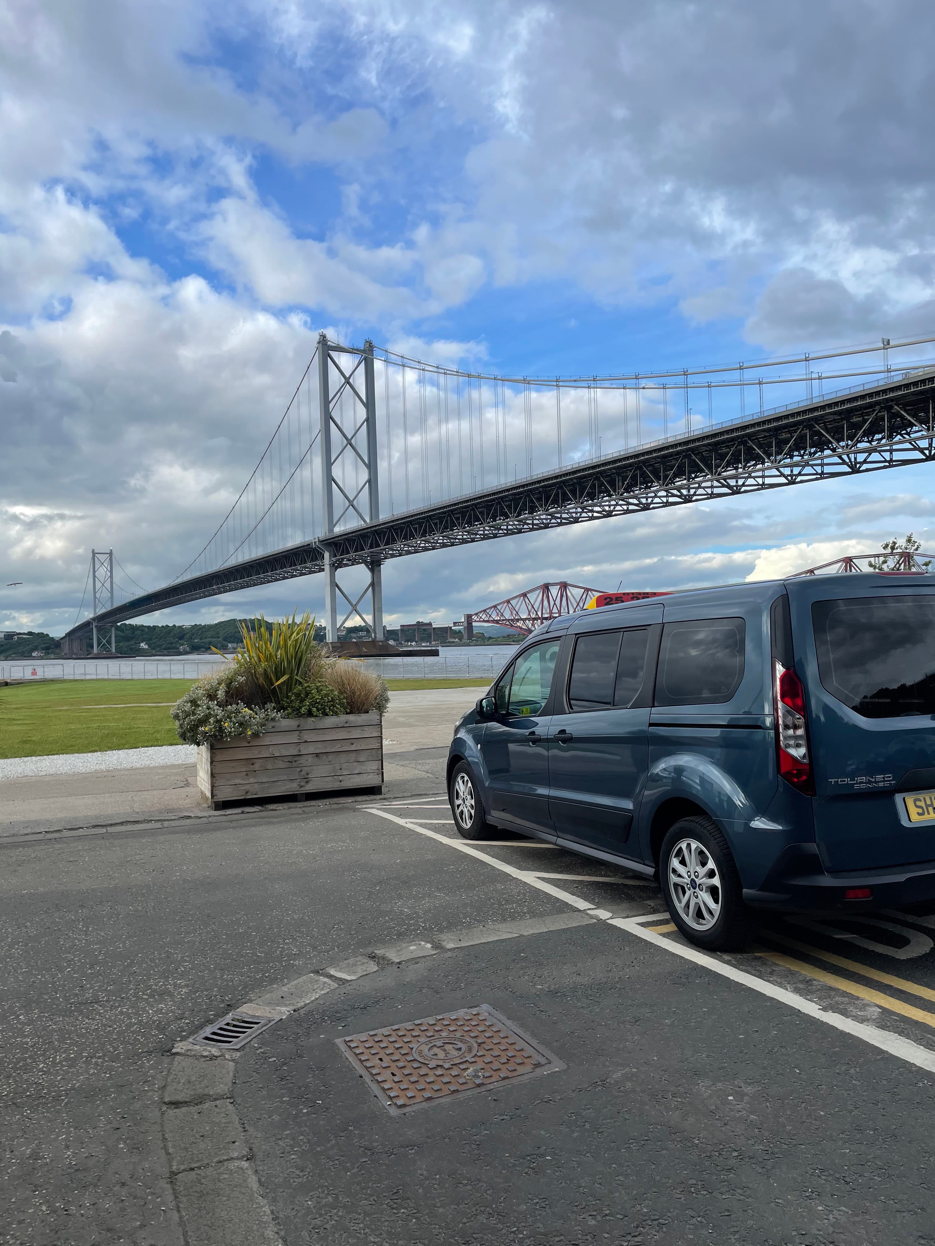 Corporate Taxis vehicle parked beside the Forth Road Bridge in daylight